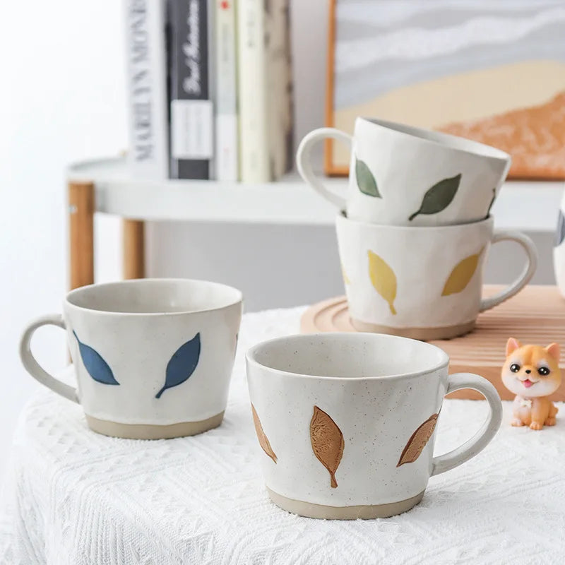 Blue Yellow Brown And Green Leaves On Craft Style Pottery Ceramic Mugs With Exposed Base