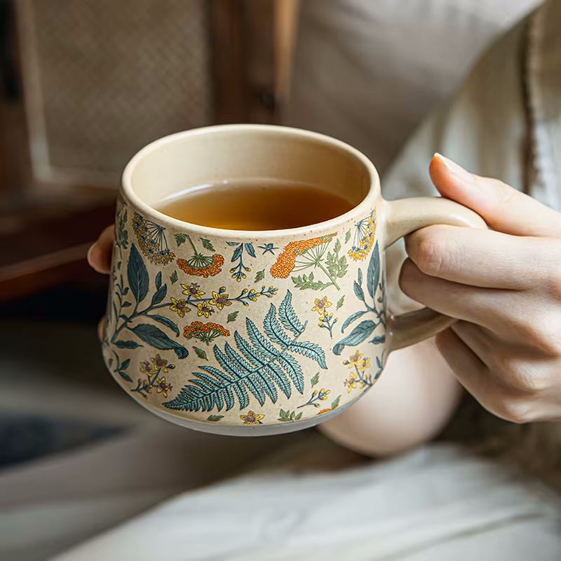 Person Holding Cozy Cup Of Tea In Flowery Fern Pattern Enchanting Botanicals Mug