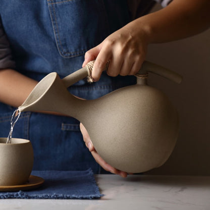 Pouring Beverage In Nordic Style Mug From Organic Modern Style Ceramic Water Pitcher