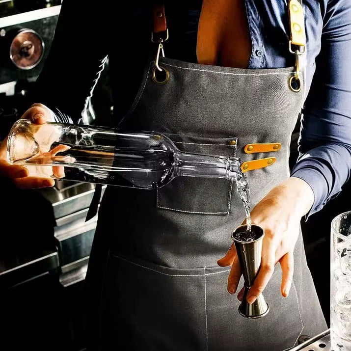 Bartender Pouring Liquor into Jigger Wearing the Cookout Style Canvas Apron