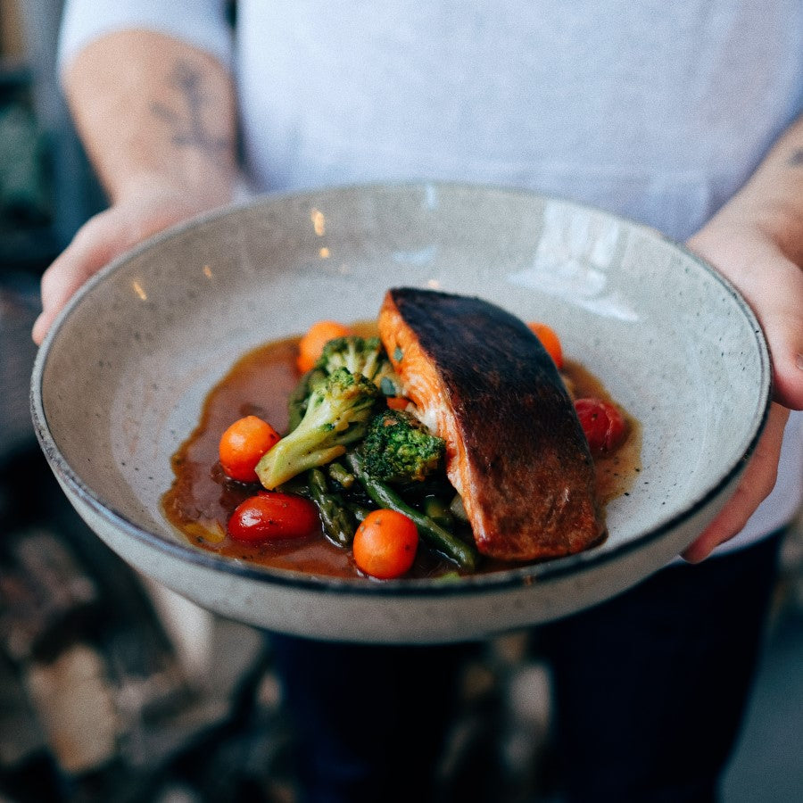 Holding A Delicious Dish Of Organic Teriyaki Salmon And Vegetables