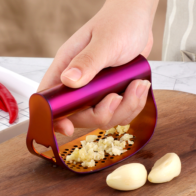 One Handed Smashing Fresh Garlic Cloves Using Terra Powders Stainless Steel Sunset Color Curved Garlic Rocker