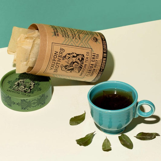 Eco Friendly Canister Of Organic Tea Yaupon Brothers Florida Chai Holly Tea Leaves And Cup Of Tea